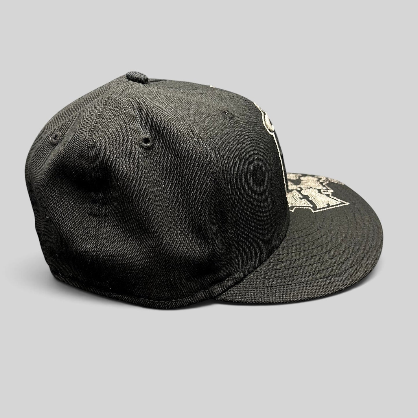 Raree Finds black New Era 59FIFTY Los Angeles Angels fitted hat with silver embroidered logo pattern on the brim