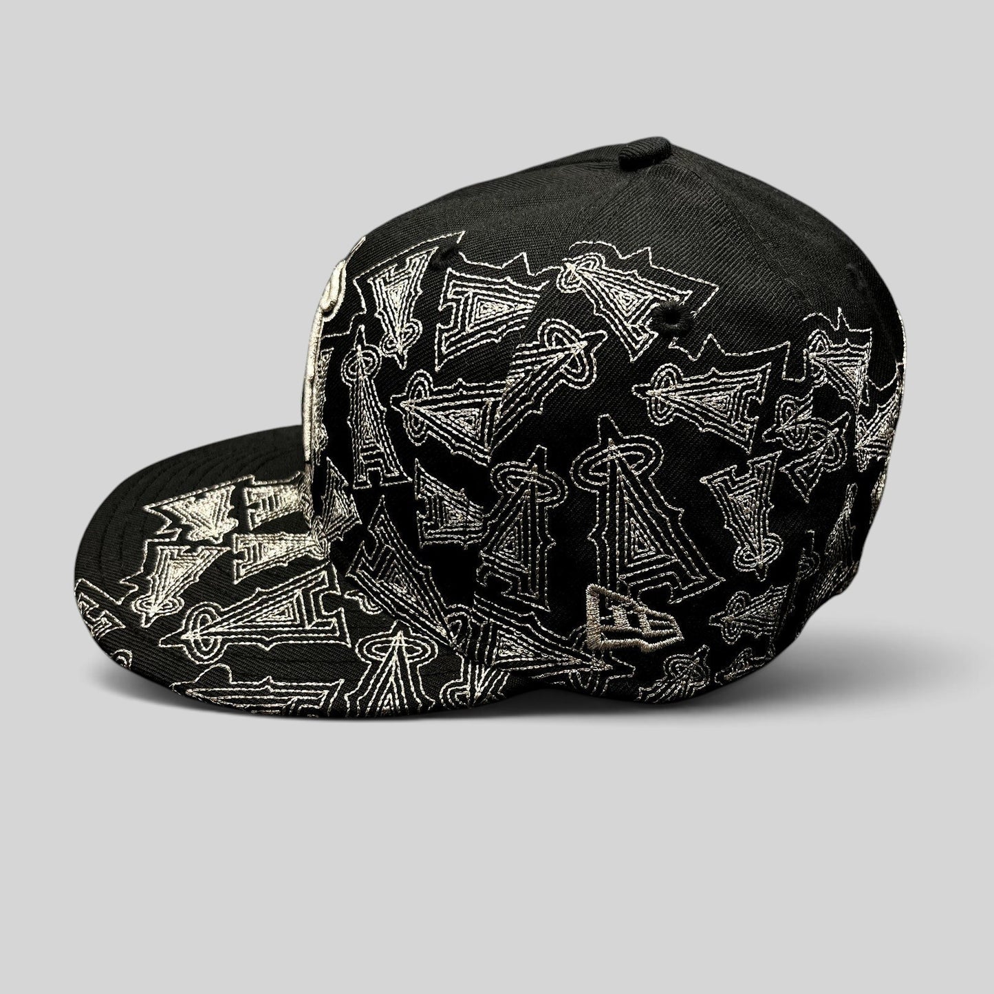 Raree Finds black New Era 59FIFTY Los Angeles Angels fitted hat with silver embroidered all-over logo pattern