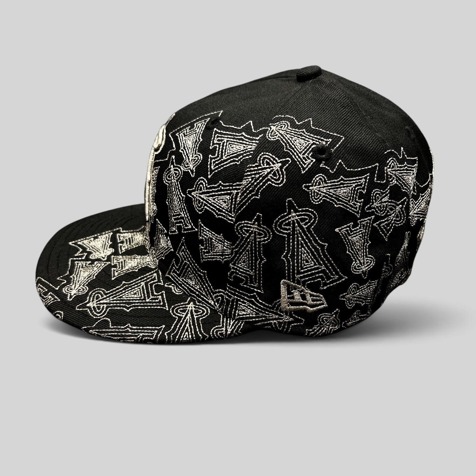 Raree Finds black New Era 59FIFTY Los Angeles Angels fitted hat with silver embroidered all-over logo pattern