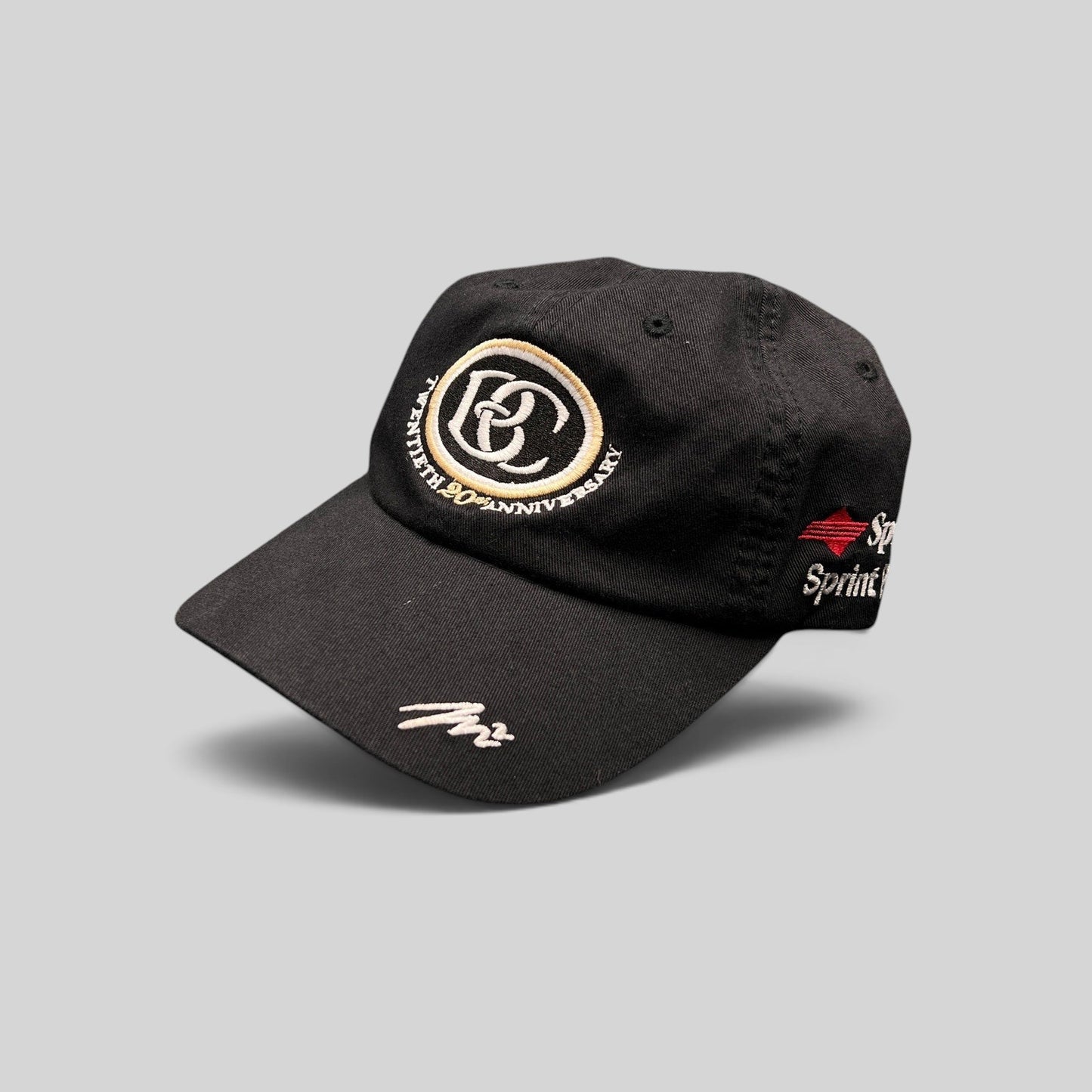 Raree Finds black cotton unstructured hat featuring a cream and black BC 20th anniversary logo and Sprint embroidery.