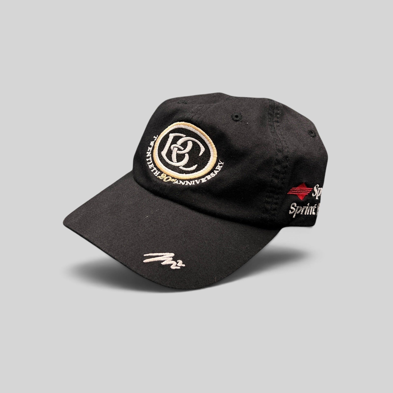 Raree Finds black cotton unstructured hat featuring a cream and black BC 20th anniversary logo and Sprint embroidery.
