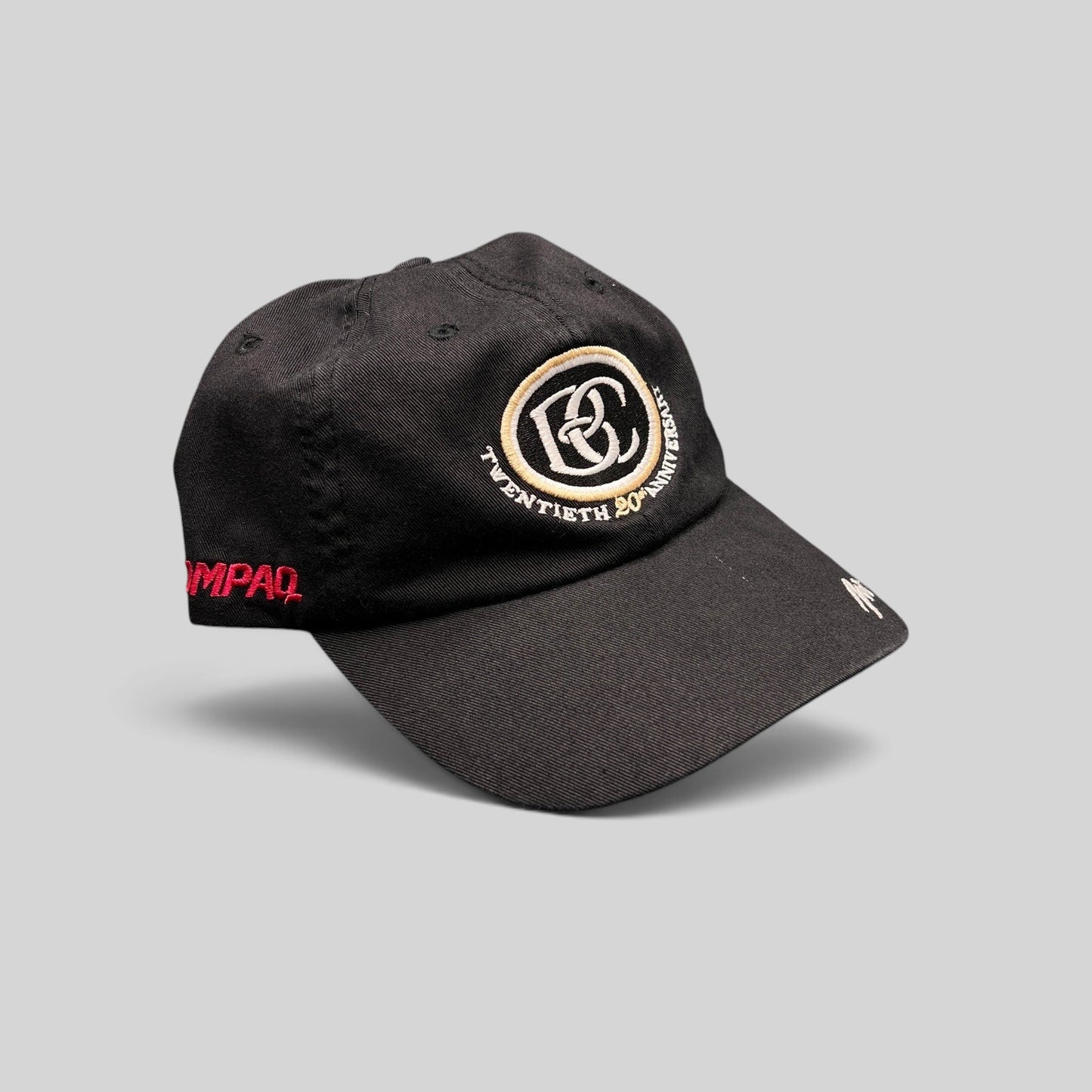 Raree Finds black cotton unstructured hat featuring a cream and black BC 20th anniversary logo and side embroidery.