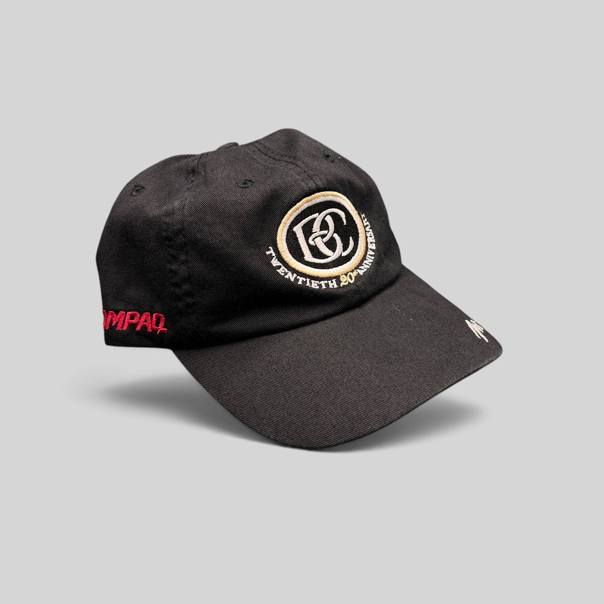 Raree Finds black cotton unstructured hat featuring a cream and black BC 20th anniversary logo and side embroidery.