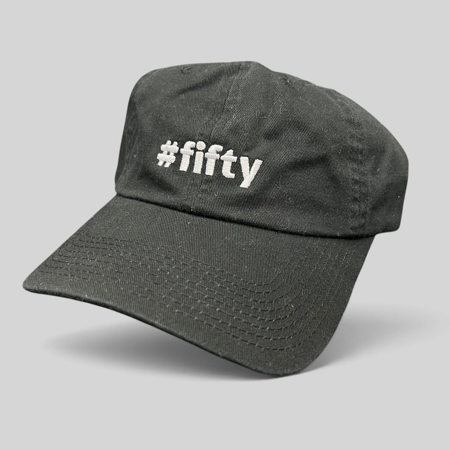 Raree Finds black cotton strapback hat with white #fifty embroidery, celebrating the Aspen 2017 anniversary.