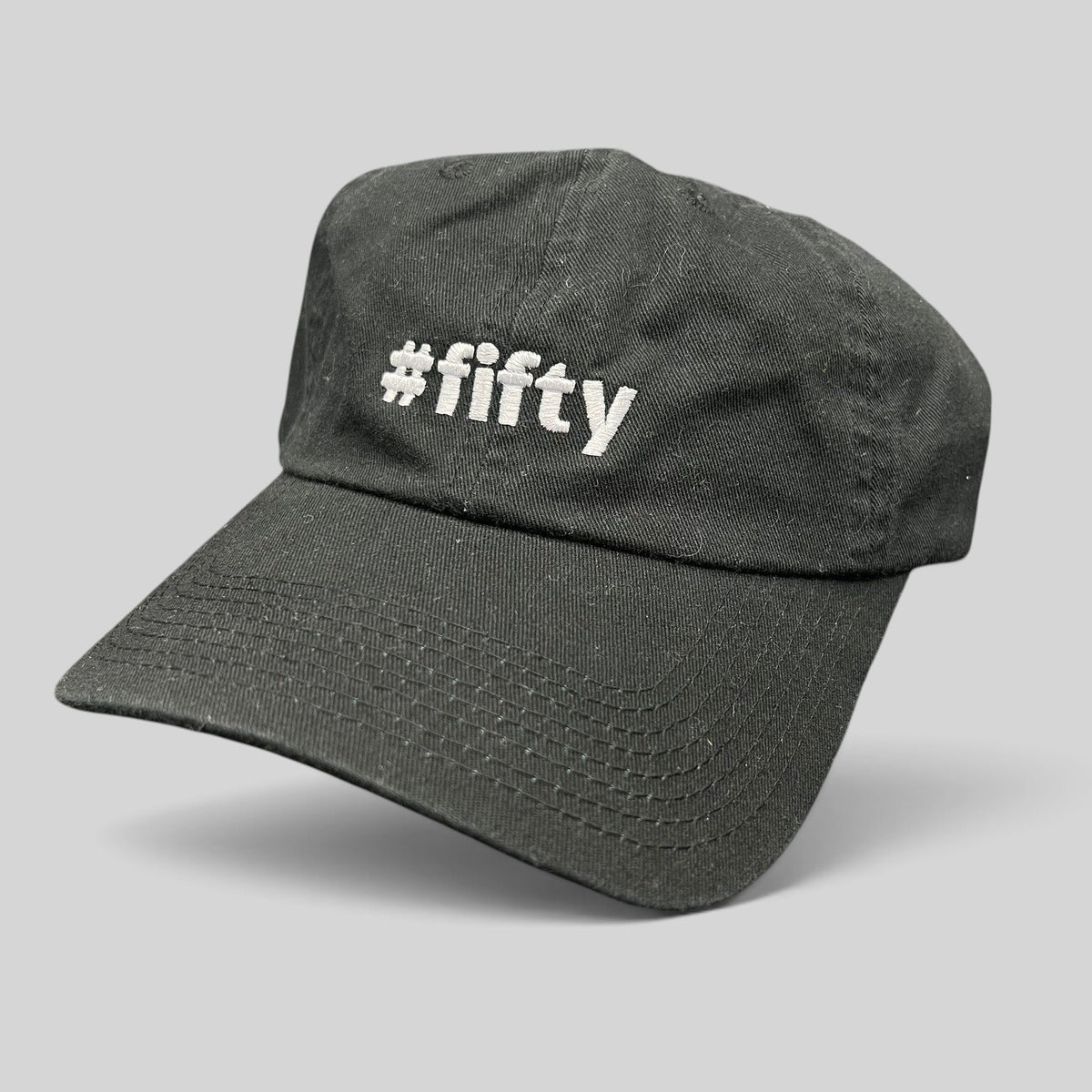 Raree Finds black cotton strapback hat with white #fifty embroidery, celebrating the Aspen 2017 anniversary.