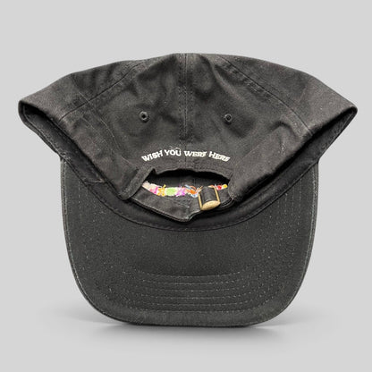 Raree Finds black cotton strapback hat with Wish You Were Here embroidery on the back and metal slider closure