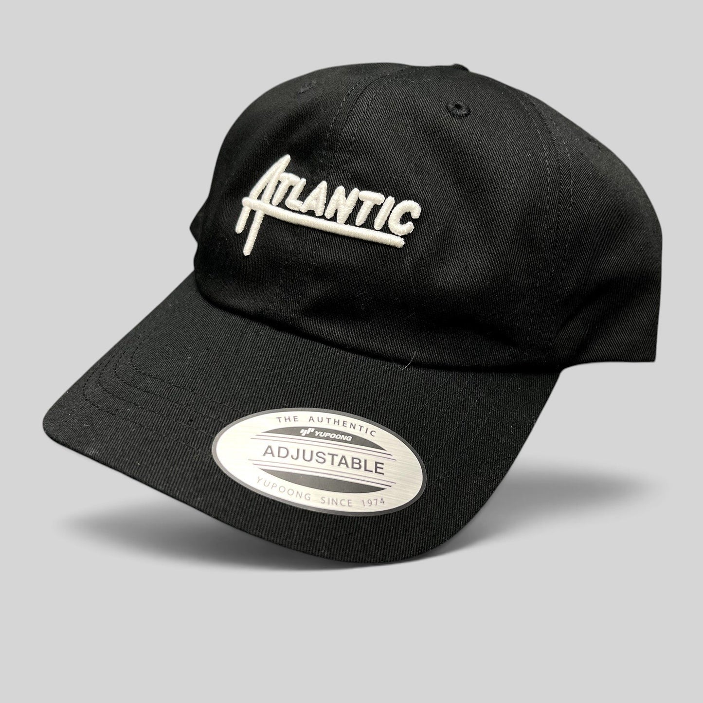 Raree Finds black Yupoong Classics dad cap with white Atlantic script embroidery and curved brim