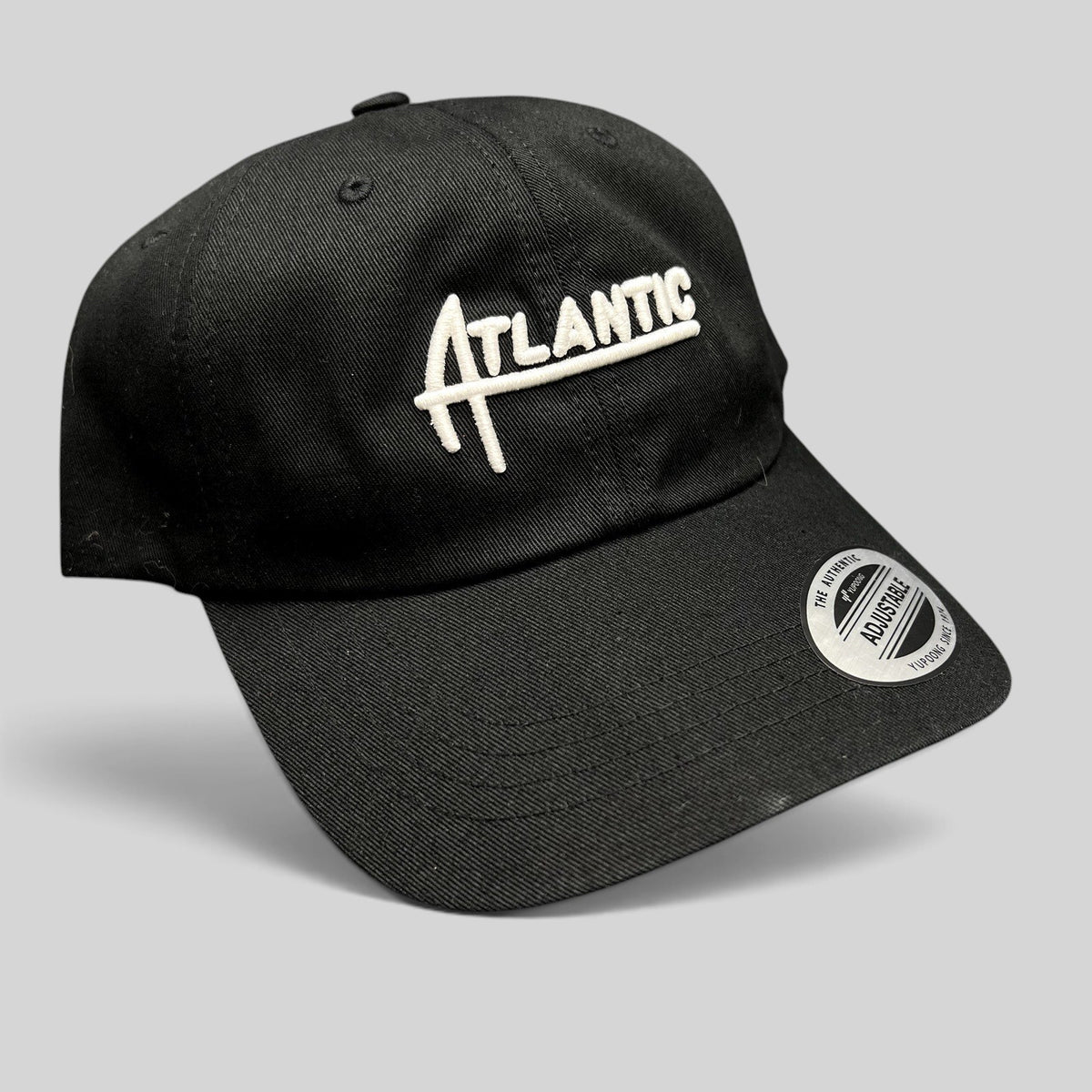 Raree Finds black cotton Yupoong Classics dad cap with white embroidered Atlantic script logo and curved brim
