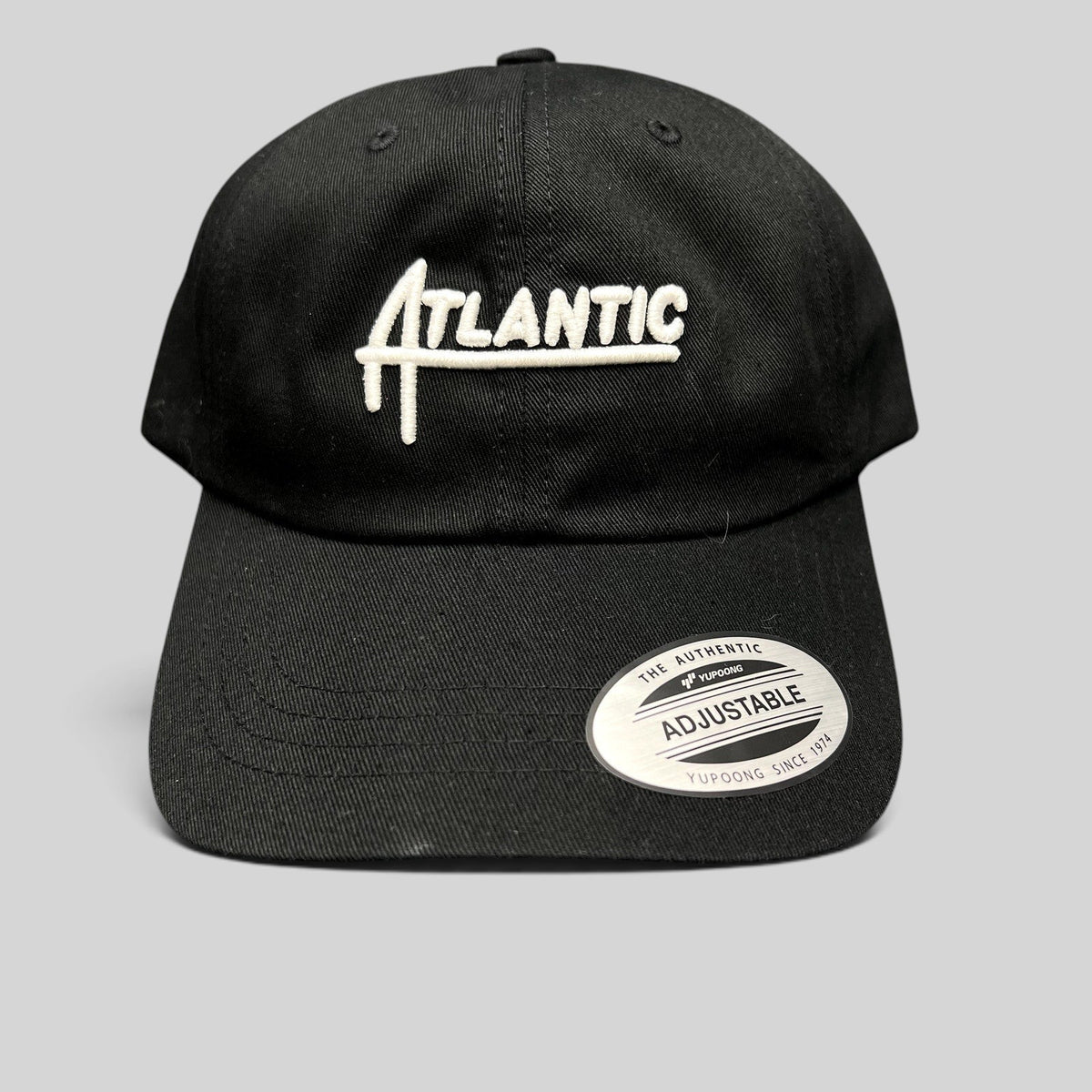 Raree Finds black cotton Yupoong Classics dad cap with white embroidered Atlantic script logo and curved brim
