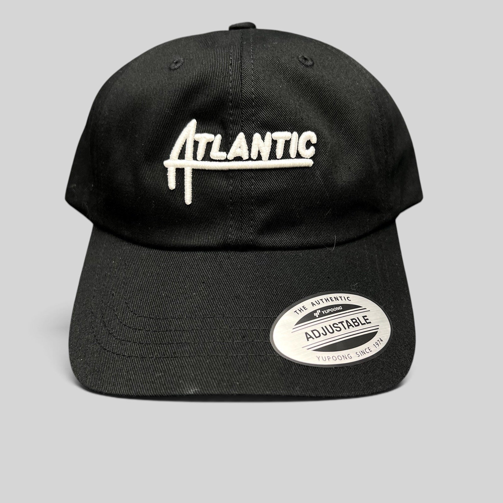 Raree Finds black cotton Yupoong Classics dad cap with white embroidered Atlantic script logo and curved brim