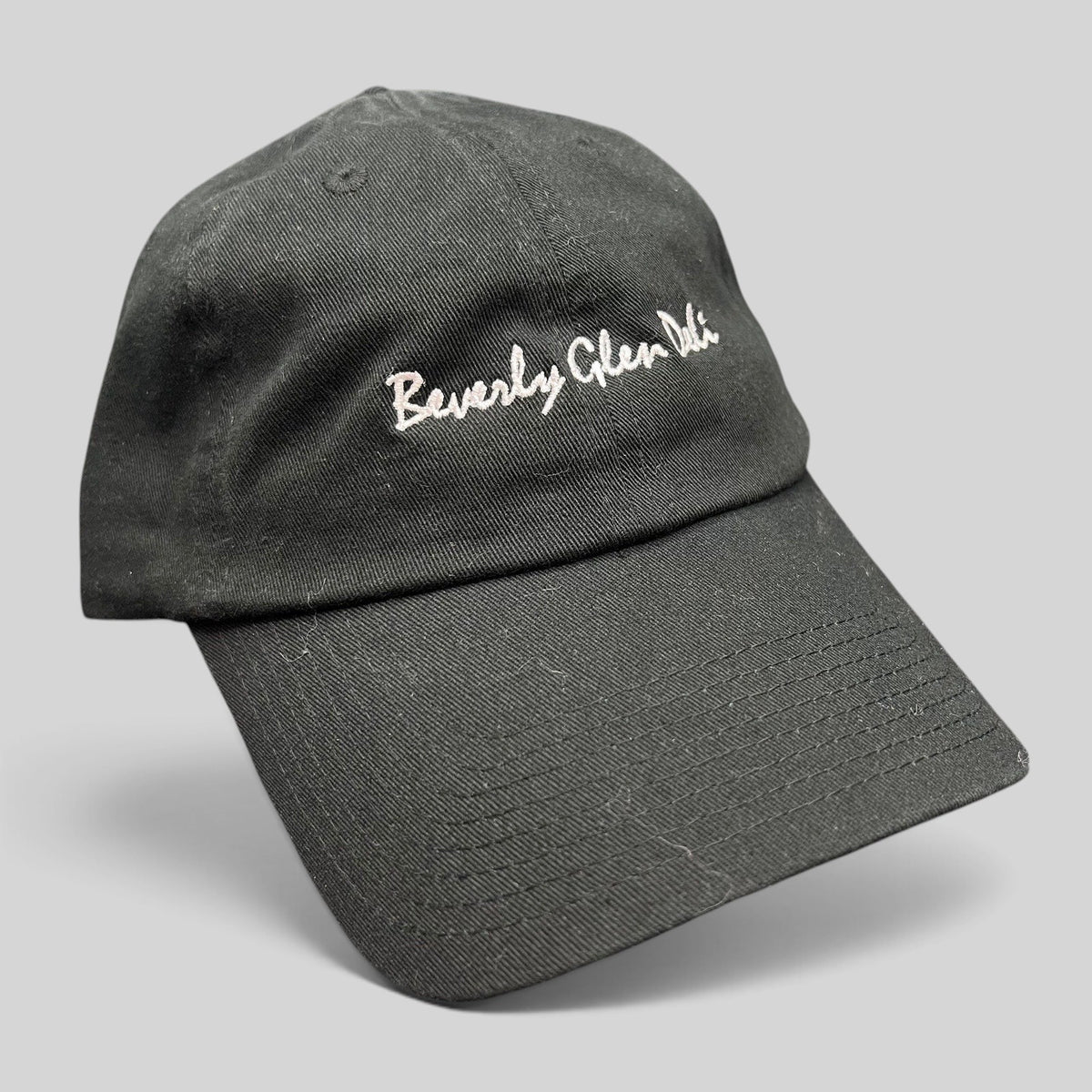 Raree Finds black cotton strapback hat with white Beverly Glen Deli cursive script embroidery and curved bill