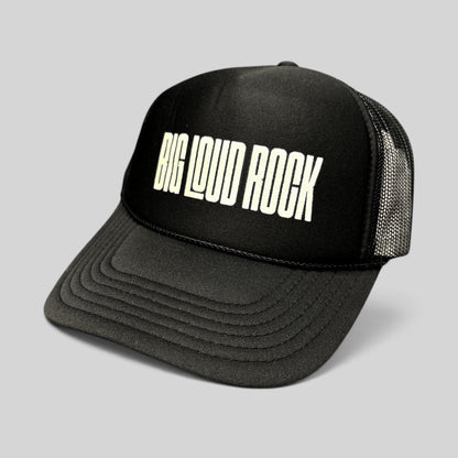 Raree Finds black Otto trucker hat with white BIG LOUD ROCK graphic, foam front, and breathable mesh back panel.