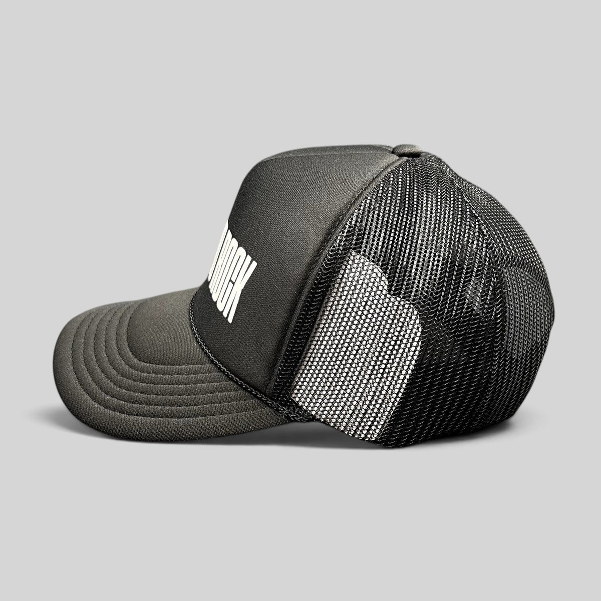 Raree Finds black Otto trucker hat with white BIG LOUD ROCK graphic, foam front, and breathable mesh back panels.