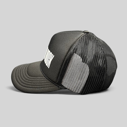Raree Finds black Otto trucker hat with white BIG LOUD ROCK graphic, foam front, and breathable mesh back panels.