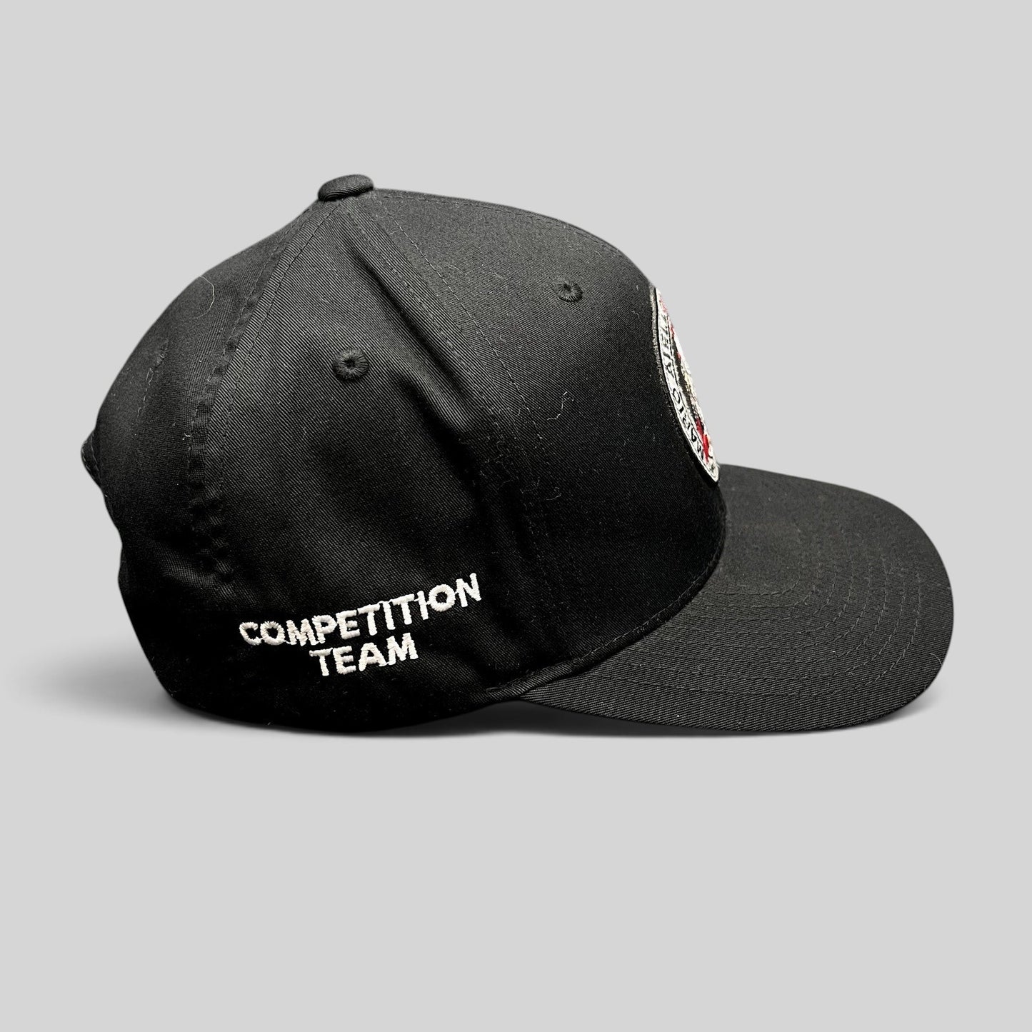 Raree Finds black Yupoong snapback hat with Competition Team embroidery on the side and BJJ logo patch on the front.