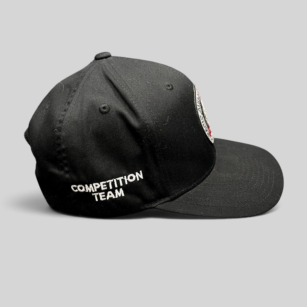 Raree Finds black Yupoong snapback hat with Competition Team embroidery on the side and BJJ logo patch on the front.