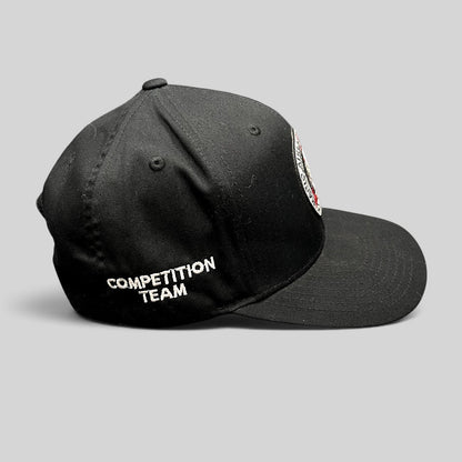 Raree Finds black Yupoong snapback hat with Competition Team embroidery on the side and BJJ logo patch on the front.