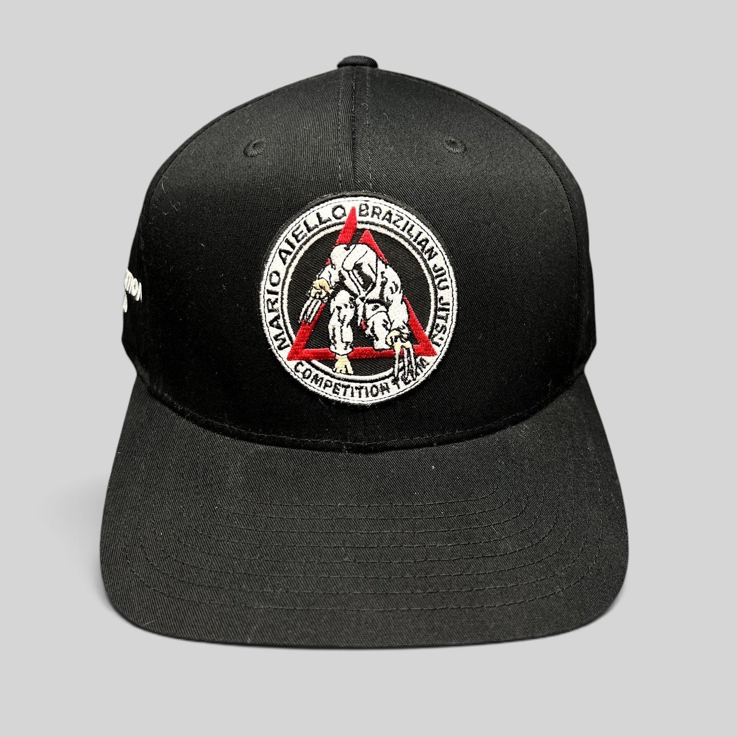 Raree Finds black Yupoong snapback hat with Mario Aiello Brazilian Jiu Jitsu Competition Team embroidered patch