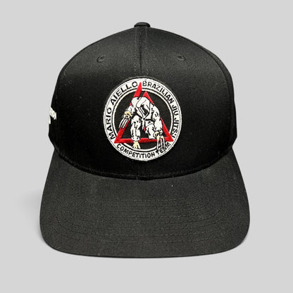 Raree Finds black Yupoong snapback hat with Mario Aiello Brazilian Jiu Jitsu Competition Team embroidered patch