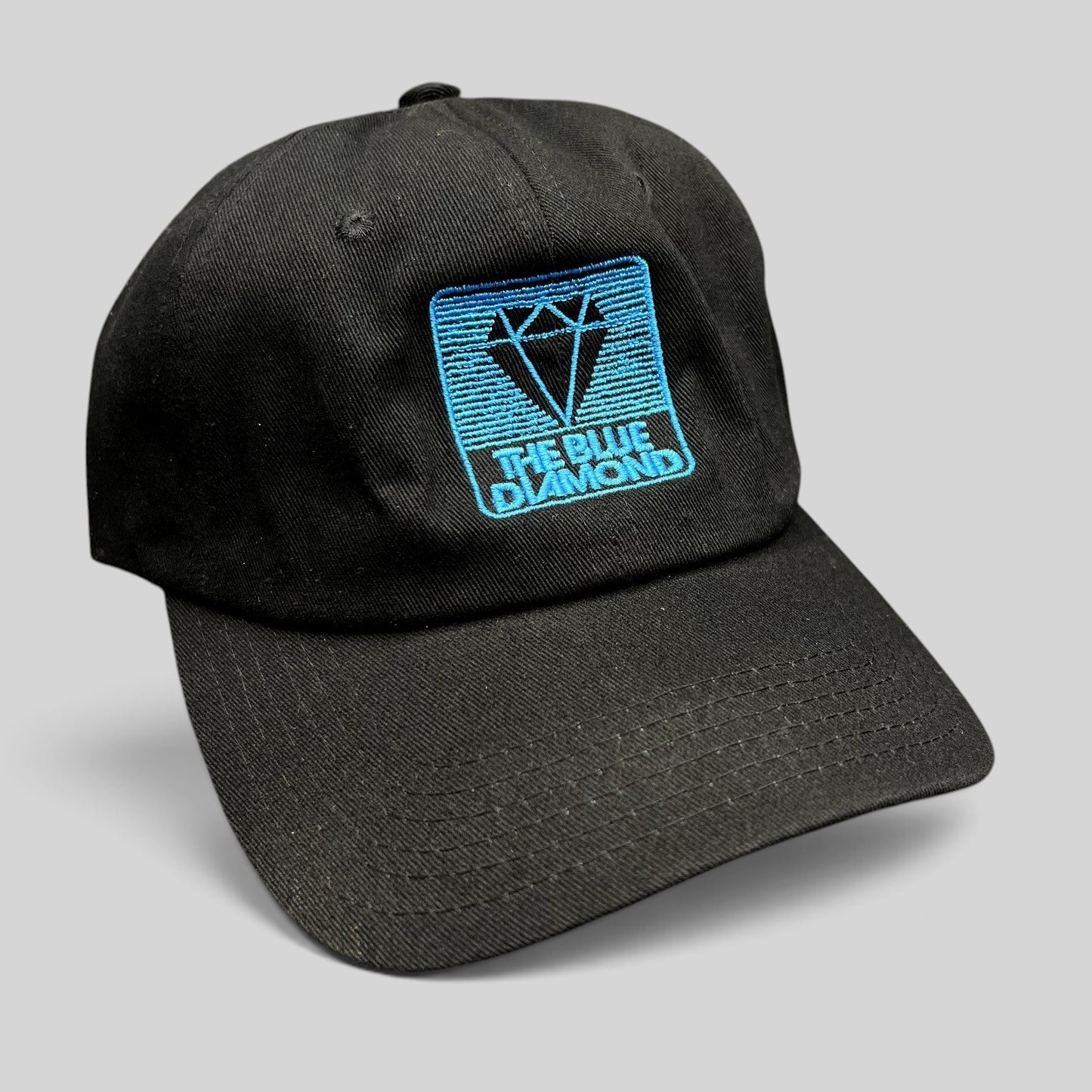 Raree Finds black cotton strapback hat with a blue embroidered The Blue Diamond logo on the front
