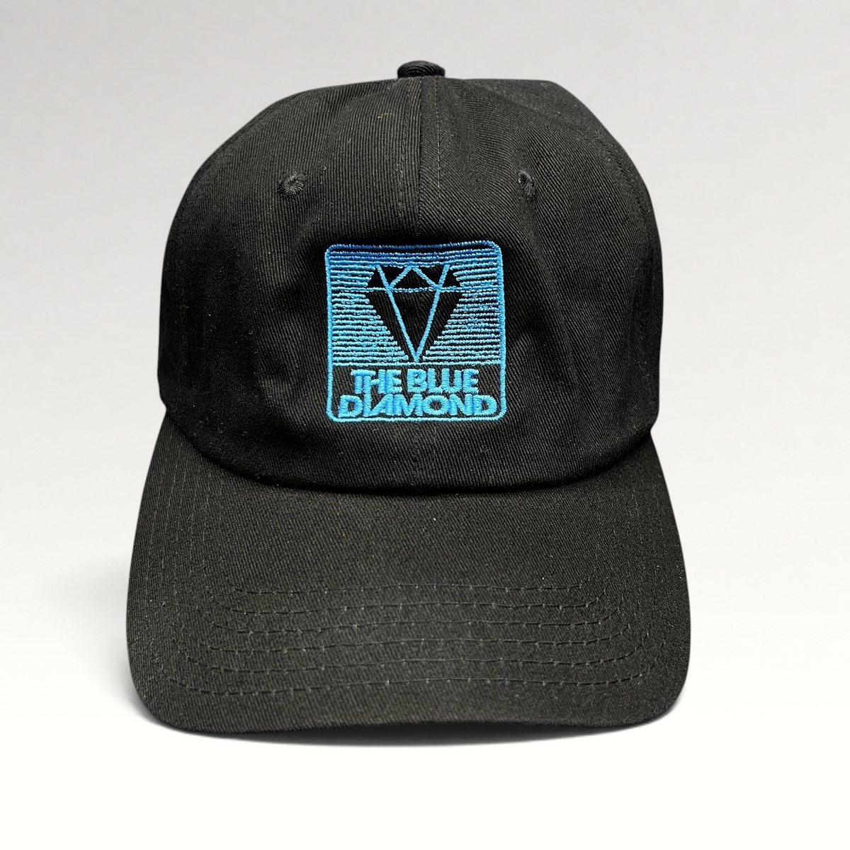 Raree Finds black cotton strapback hat with a blue embroidered The Blue Diamond logo on the front crown