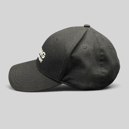 Raree Finds black The Boring Company strapback hat with white embroidered logo and curved brim, side profile view.