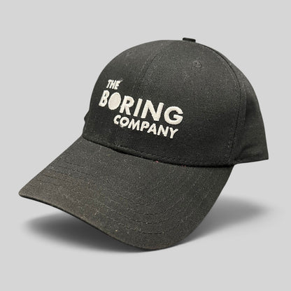 Raree Finds black The Boring Company strapback hat with white embroidered logo on the front and curved brim