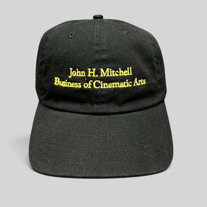 Raree Finds black cotton strapback hat with gold embroidered John H. Mitchell Business of Cinematic Arts lettering.