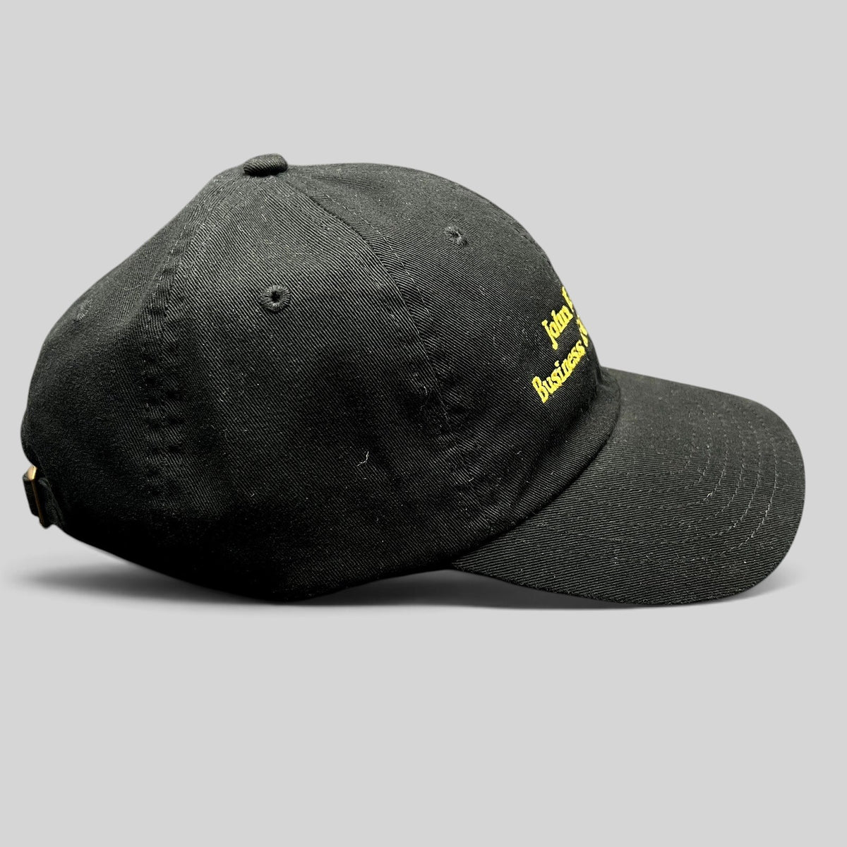 Raree Finds black cotton strapback hat with gold embroidered John H. Mitchell Business of Cinematic Arts lettering