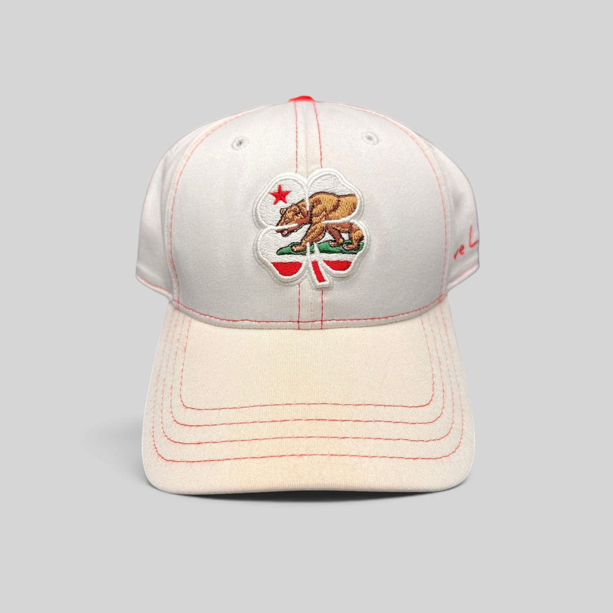 Raree Finds Black Clover California Republic hat featuring a bear and four-leaf clover embroidery on white fabric.