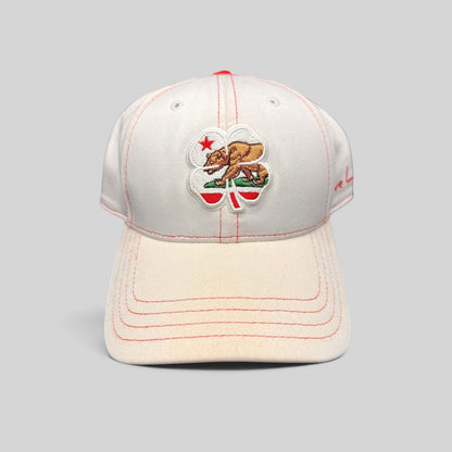 Raree Finds Black Clover California Republic hat featuring a bear and four-leaf clover embroidery on white fabric.