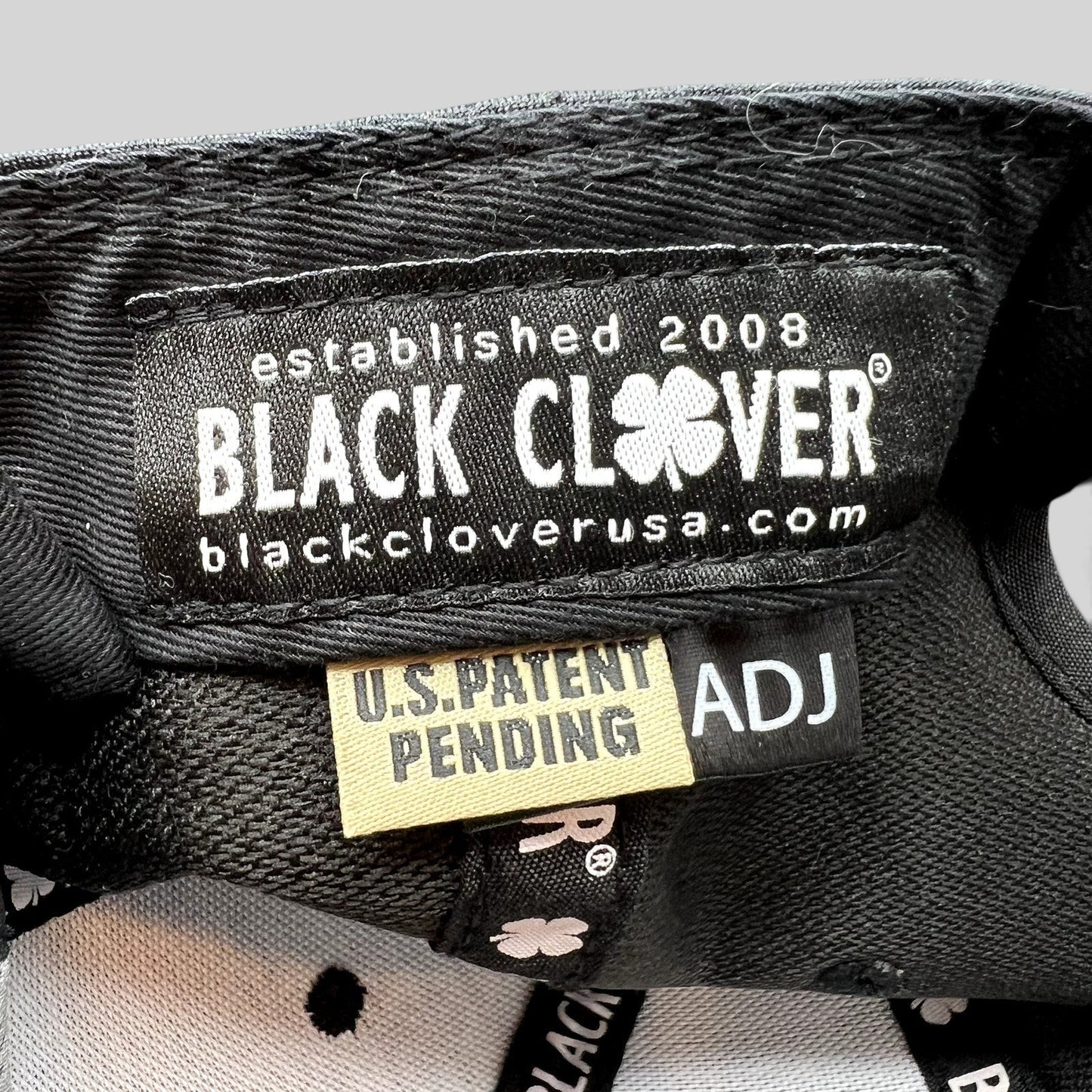 Raree Finds Black Clover hat interior label with U.S. Patent Pending tag and branded taping