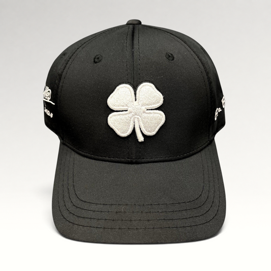 Raree Finds black snapback golf hat featuring a large white embroidered clover logo and Blessed 2024 side branding.