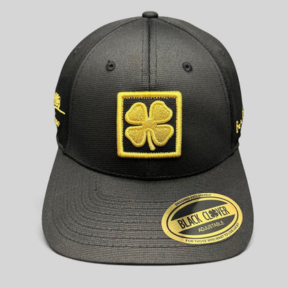 Raree Finds Black Clover x Tony Robbins 2026 black snapback hat with gold embroidered clover patch and sticker