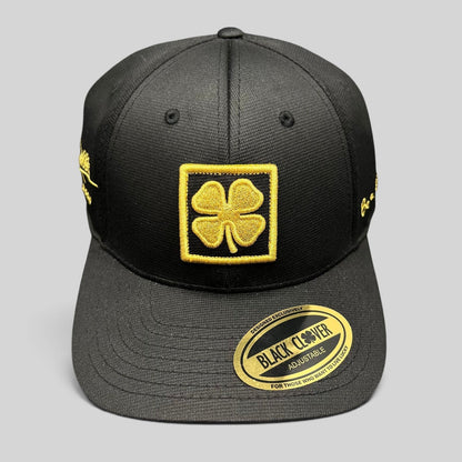Raree Finds Black Clover x Tony Robbins 2026 limited edition black snapback hat with gold clover patch and embroidery