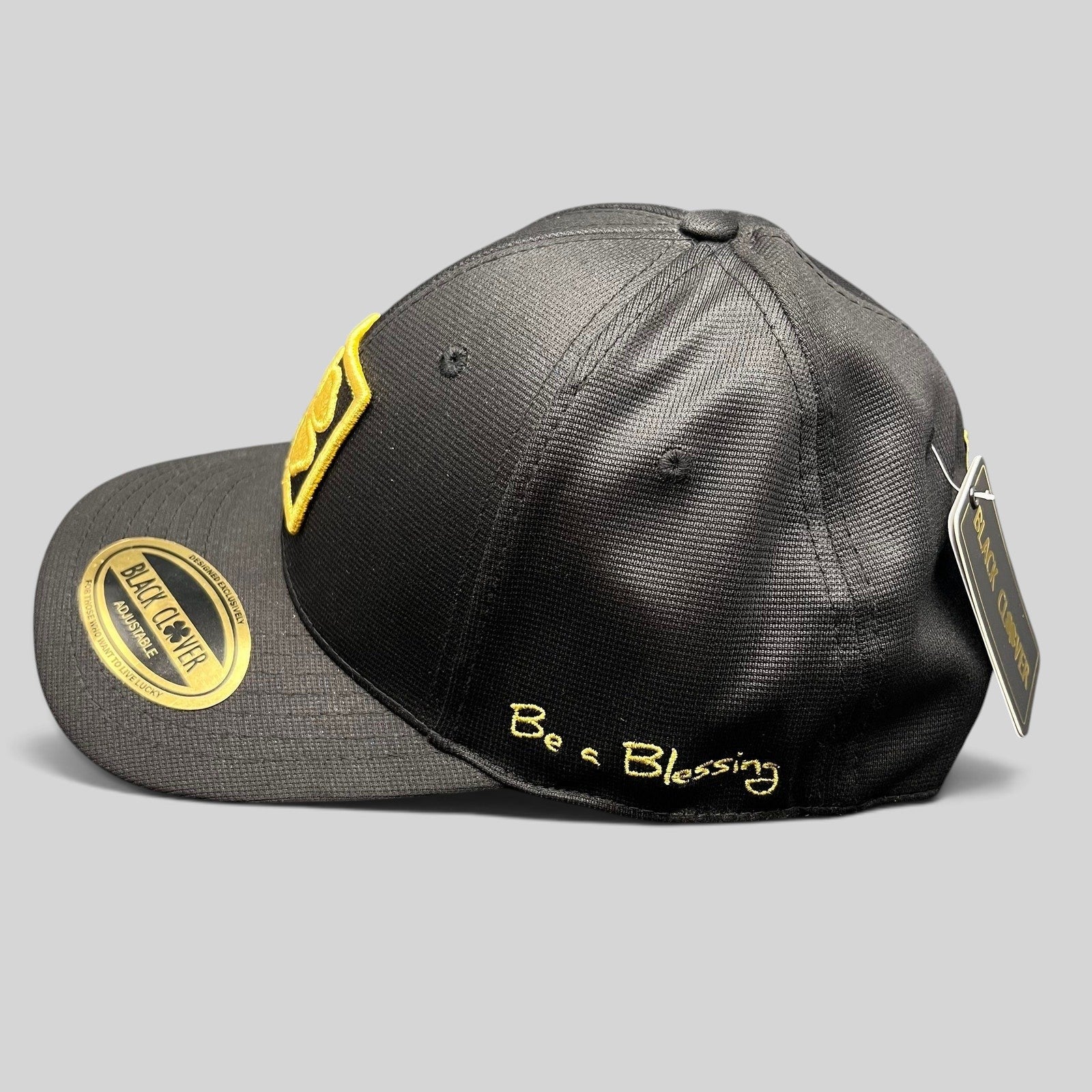 Raree Finds Black Clover x Tony Robbins 2026 limited edition black snapback hat with gold clover patch and Blessed script.