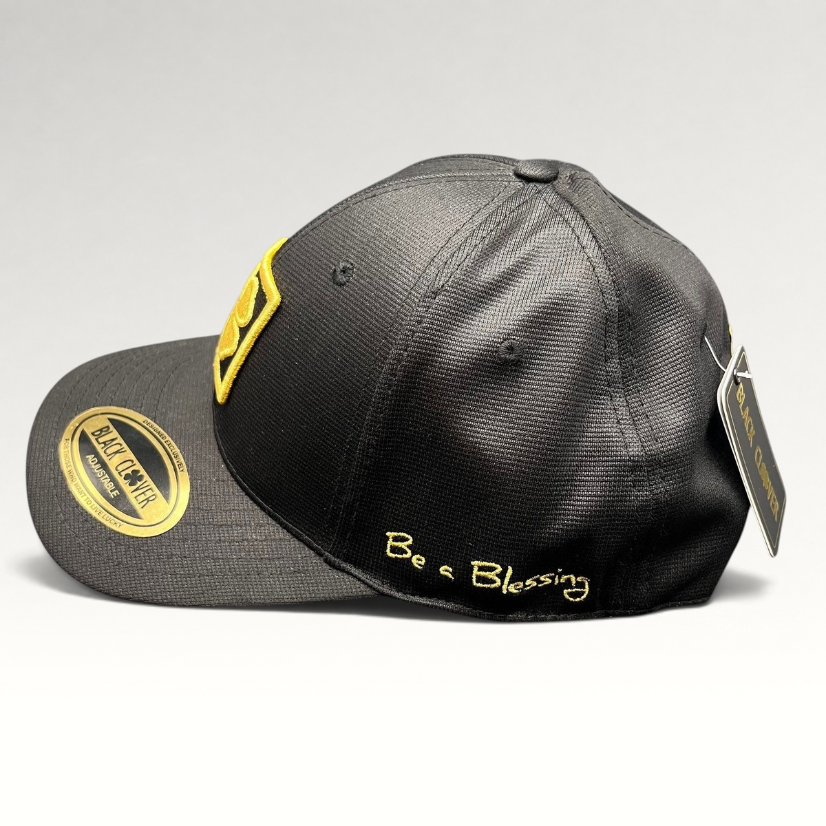 Raree Finds Black Clover x Tony Robbins 2026 limited edition black snapback hat with gold clover patch and Blessed script.