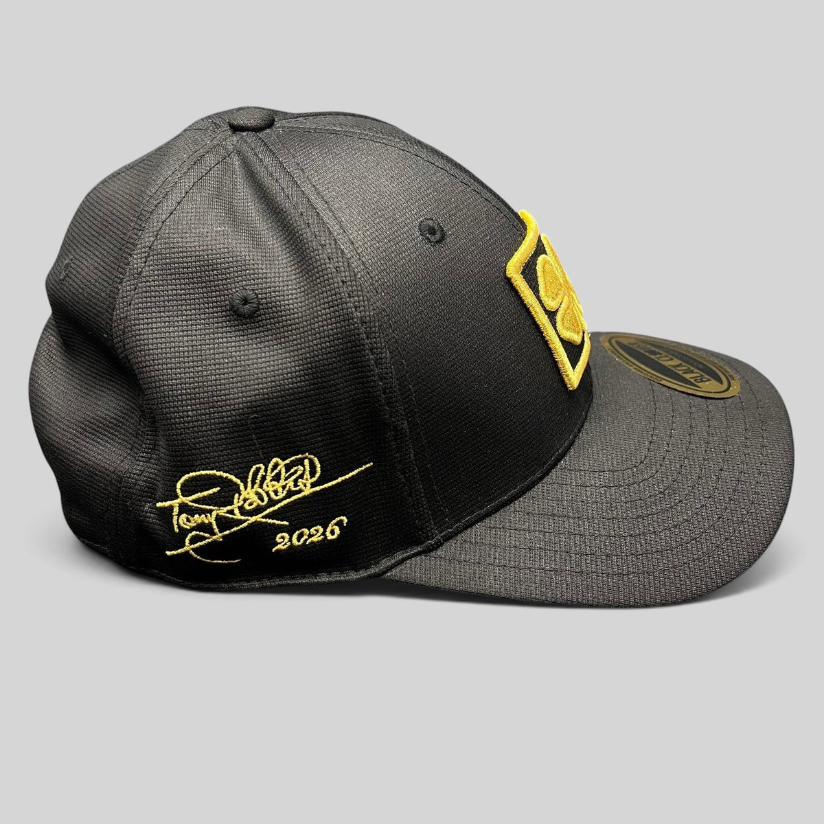 Raree Finds Black Clover x Tony Robbins 2026 black snapback hat with gold clover patch and signature embroidery