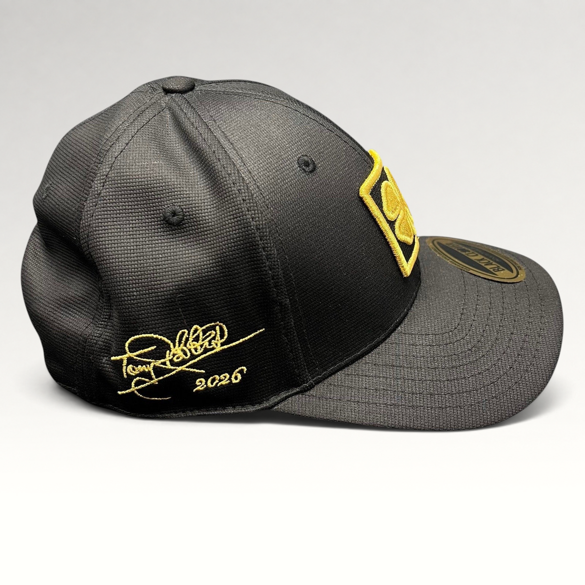 Raree Finds Black Clover x Tony Robbins 2026 black snapback hat with gold clover patch and signature embroidery