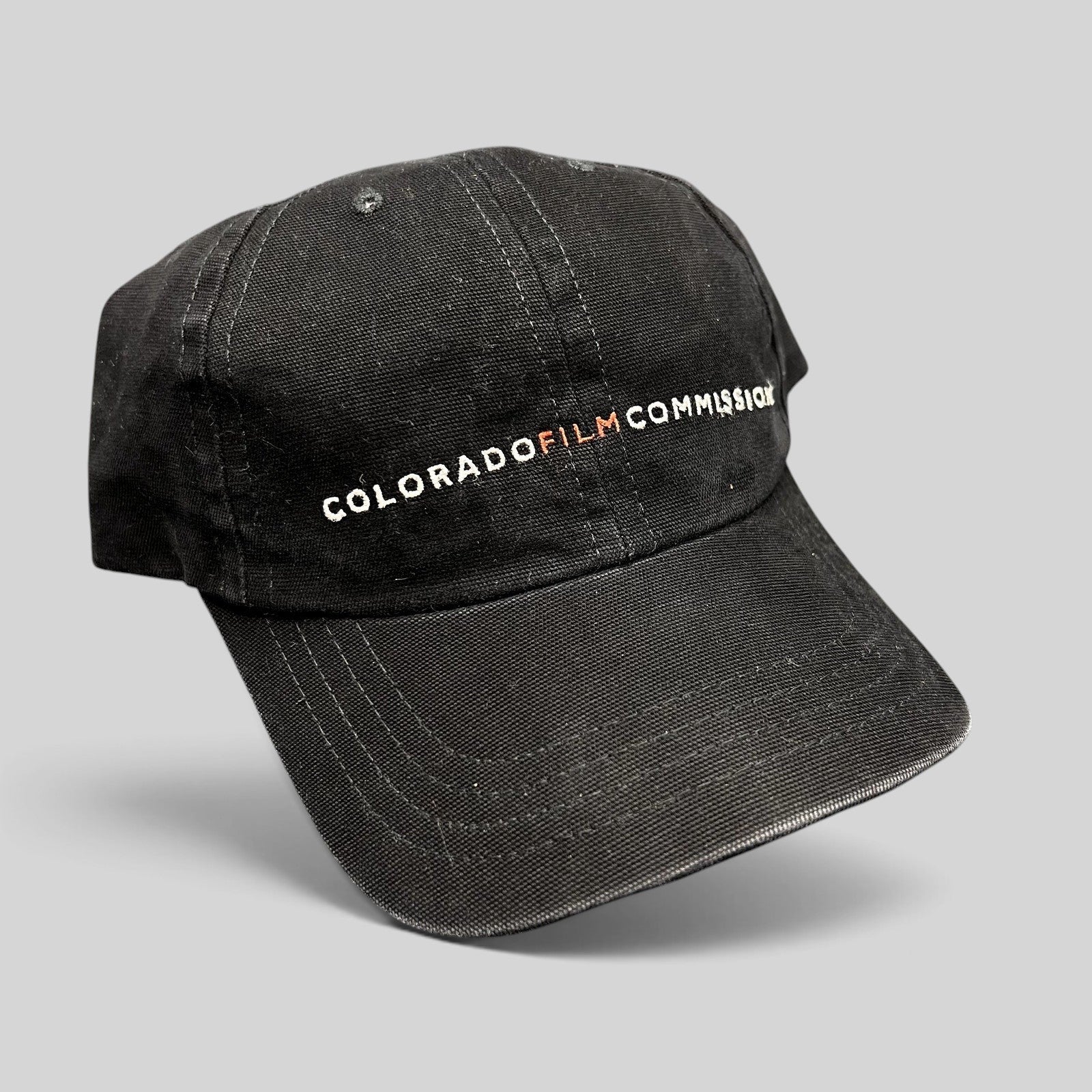 Raree Finds black Colorado Film Commission cotton strapback hat with embroidered logo and red M accent