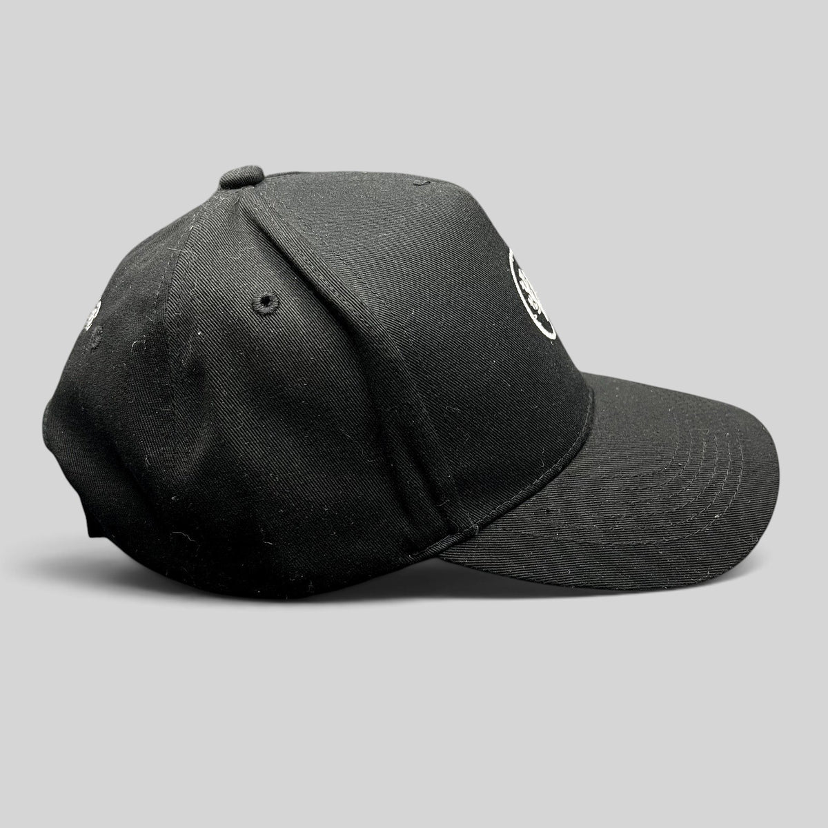 Raree Finds black Coral Gardeners strapback cap with embroidered coral logo, side profile view