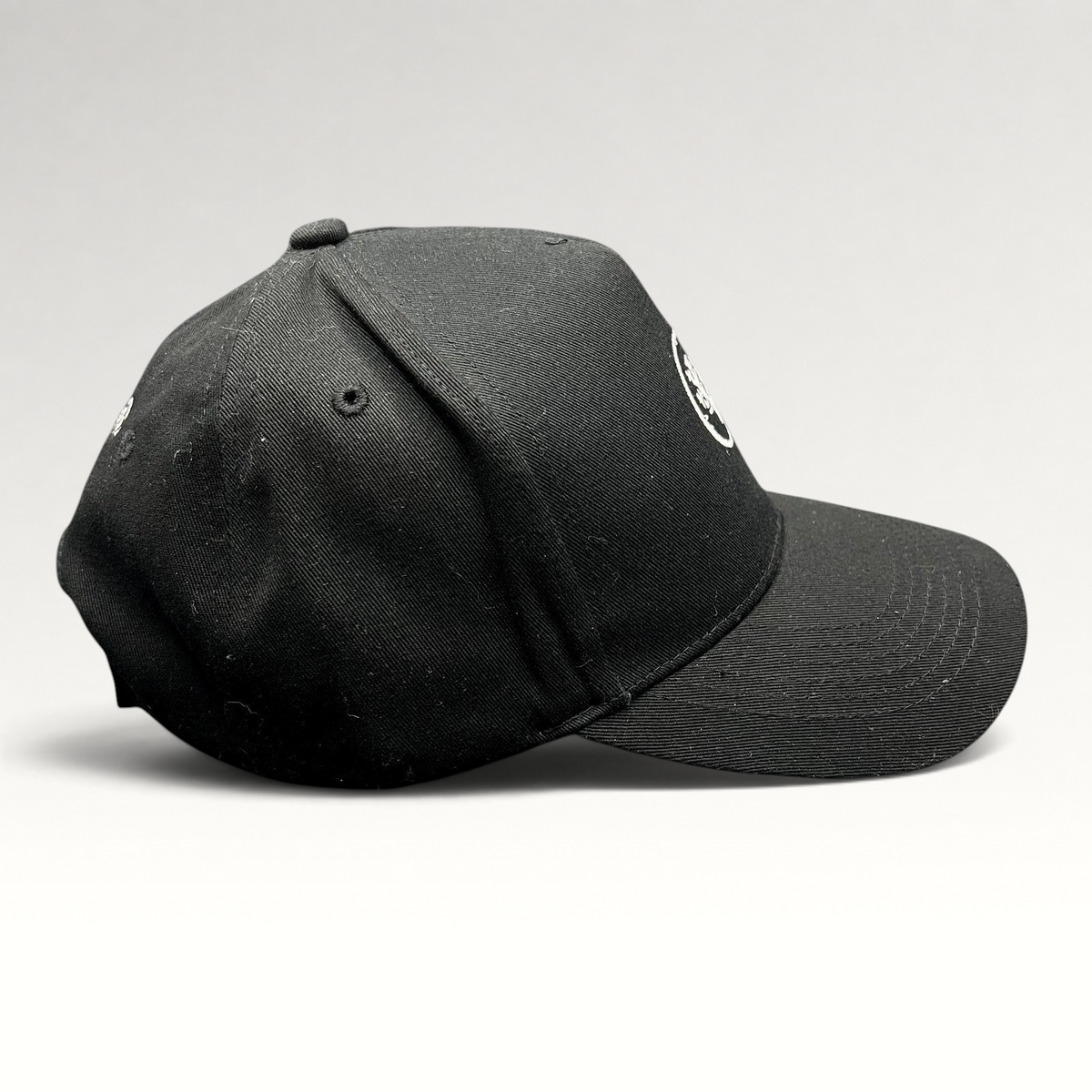 Raree Finds black Coral Gardeners strapback cap with embroidered coral logo, side profile view