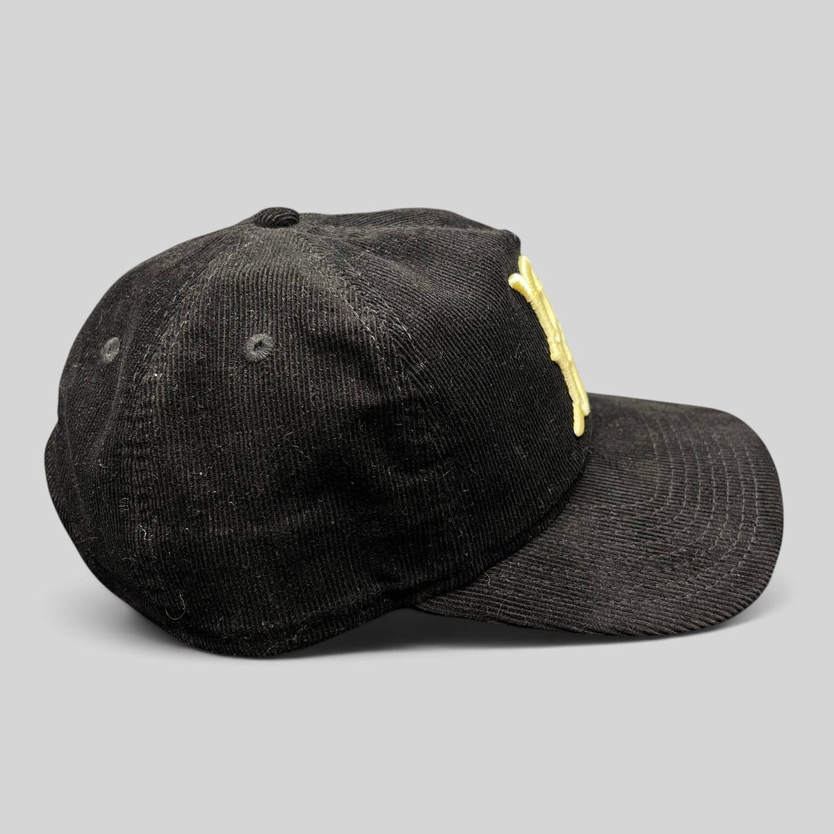Raree Finds black corduroy Brooklyn Dodgers 9TWENTY snapback hat with cream embroidered logo, side profile view.