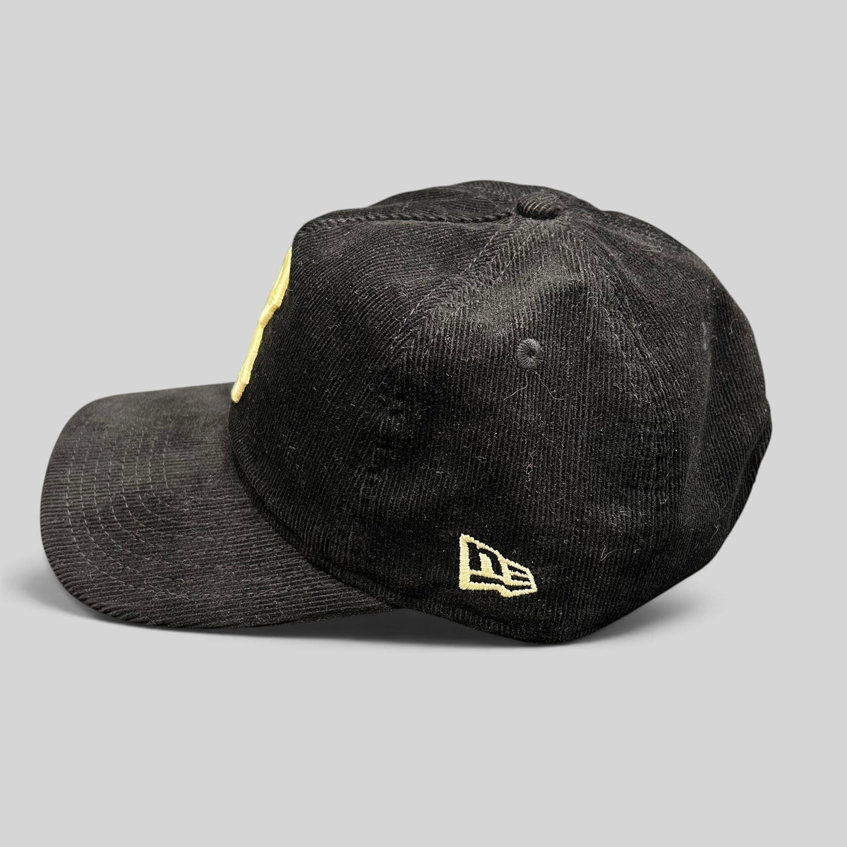 Raree Finds black corduroy New Era 9TWENTY Brooklyn Dodgers snapback hat with cream embroidery, side profile view.