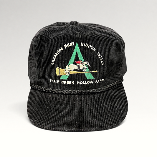 Raree Finds vintage black corduroy strapback hat with Arapahoe Hunt horse and rider embroidery and braided rope trim.