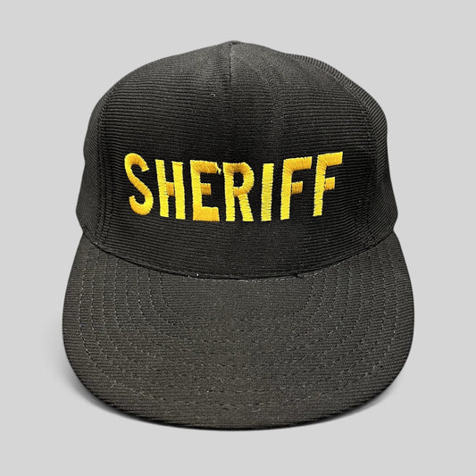 Raree Finds vintage black corduroy snapback hat with gold embroidered SHERIFF lettering and high-profile crown.