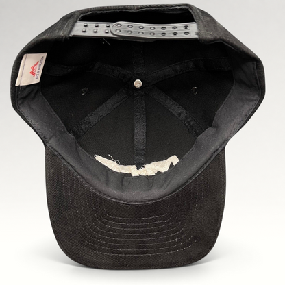 Interior view of a black Raree Finds vintage Mission Impossible 2 corduroy snapback hat showing the adjustable strap.