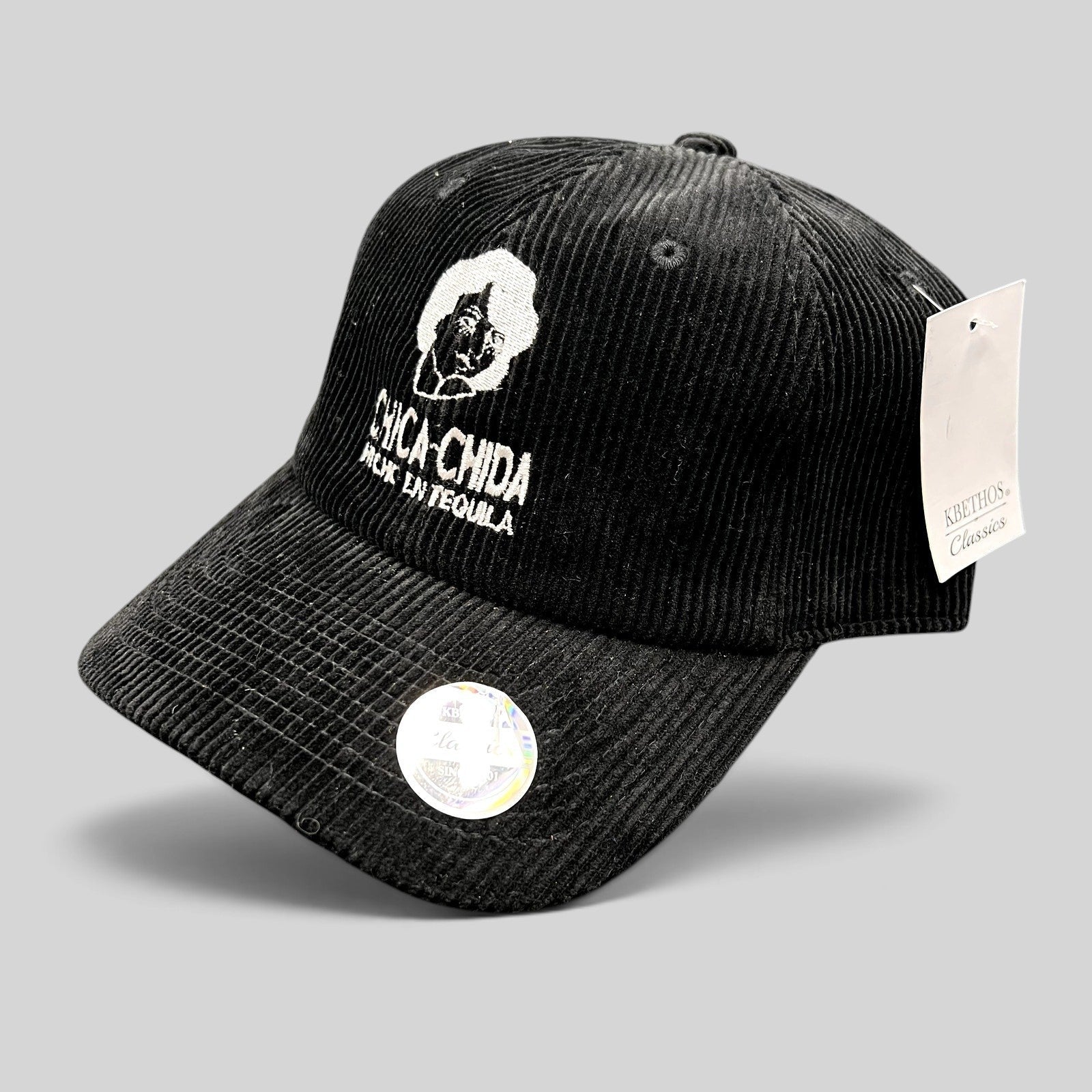 Raree Finds black corduroy strapback hat featuring white Chica~Chida Hecho en Tequila embroidery and KBETHOS tag.