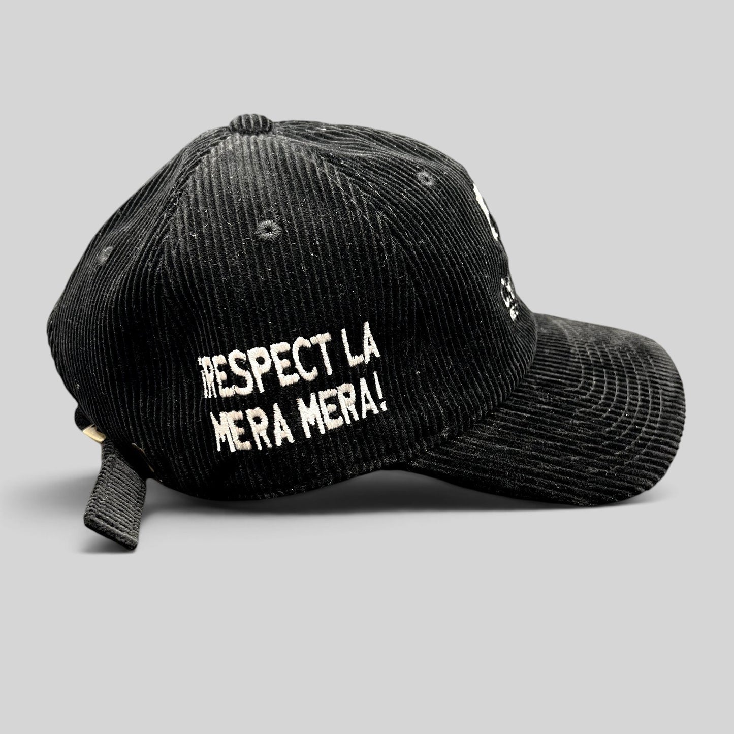 Raree Finds black corduroy strapback hat with white Respect La Mera Mera embroidery on the side