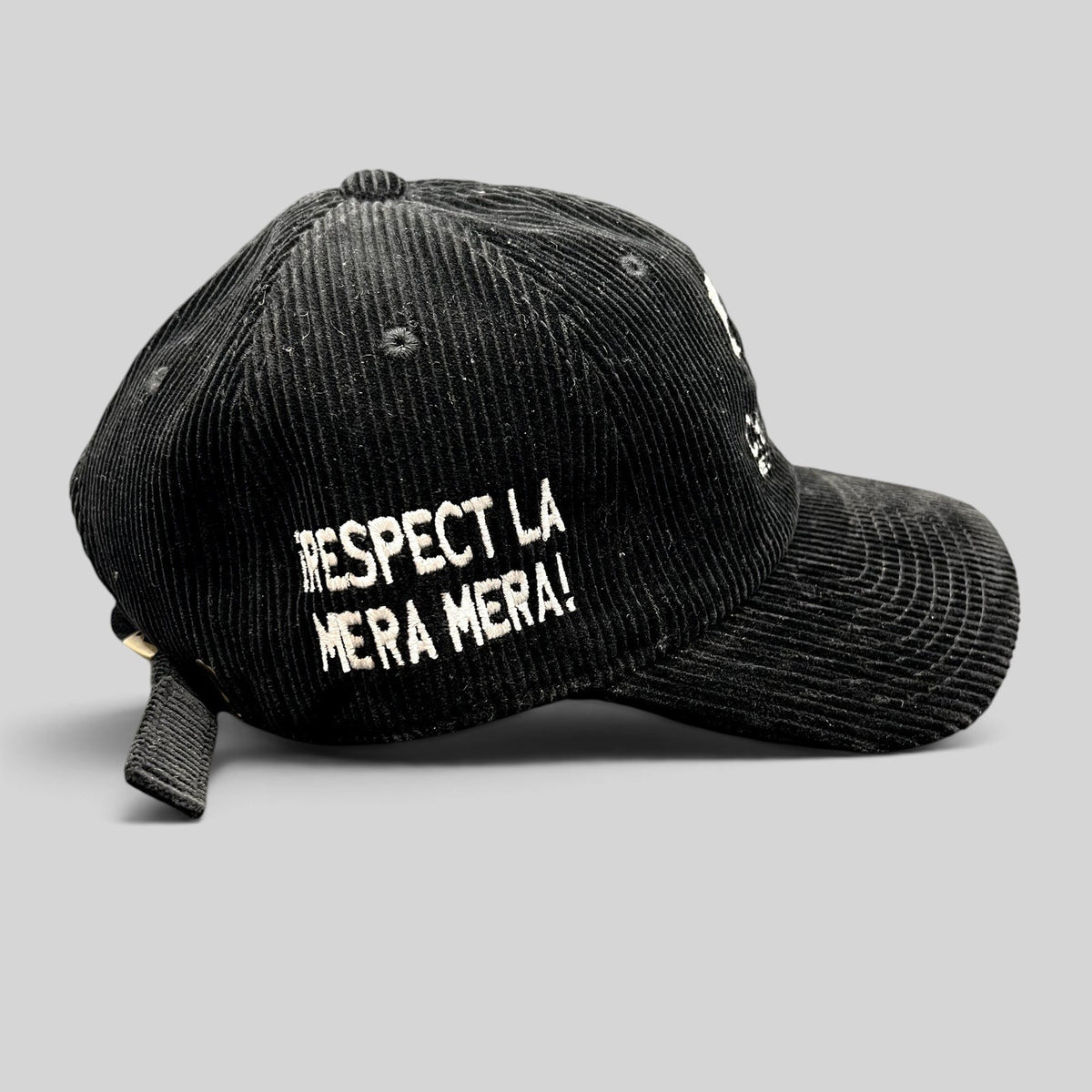 Raree Finds black corduroy strapback hat with white Respect La Mera Mera embroidery on the side